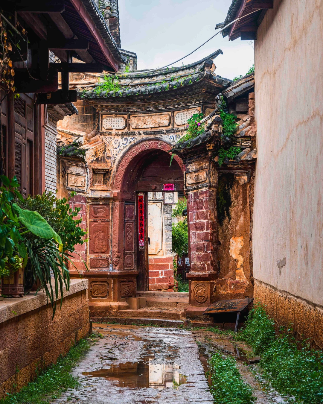 Historic lane and carved courtyard entrance in Shaxi Old Town