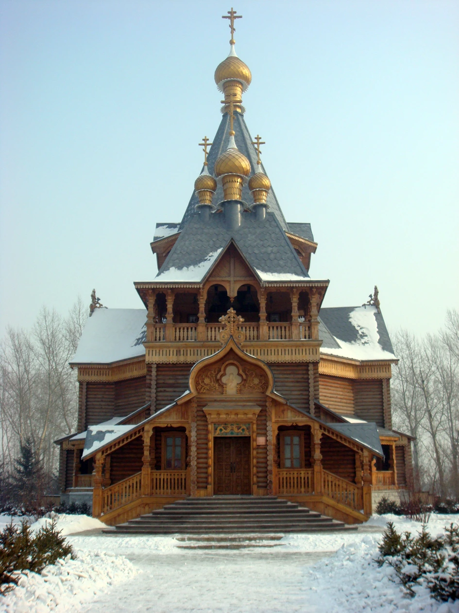Snow-covered Saint Nicholas church reconstruction at Harbin Volga Manor