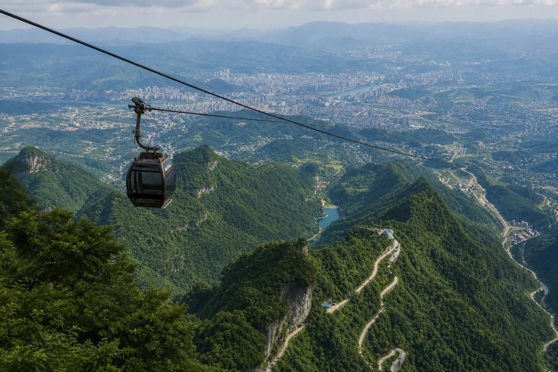 Panorama of a Tianmen cable car, the mountain road and Zhangjiajie city below