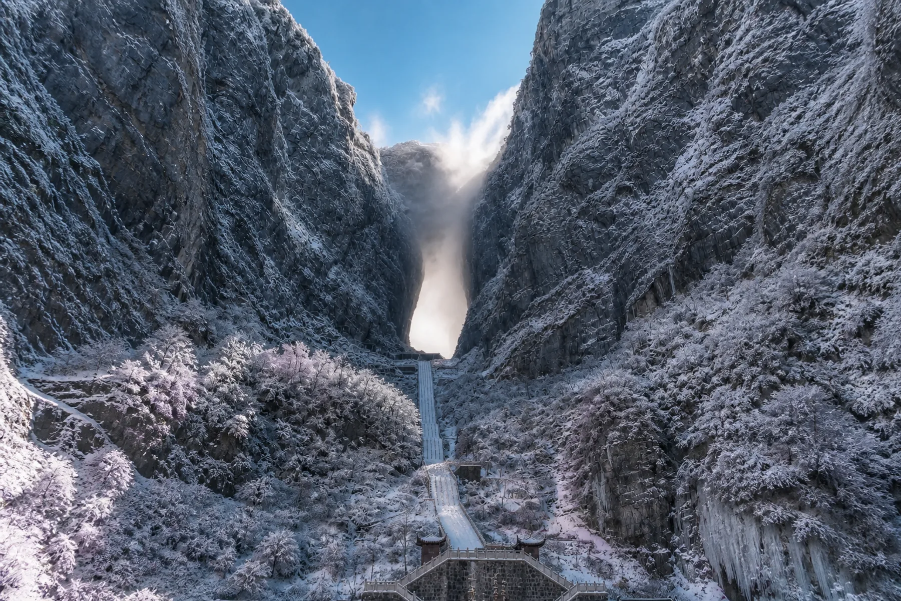 Winter view of Tianmen Cave, icy cliffs and the snow-covered stairway