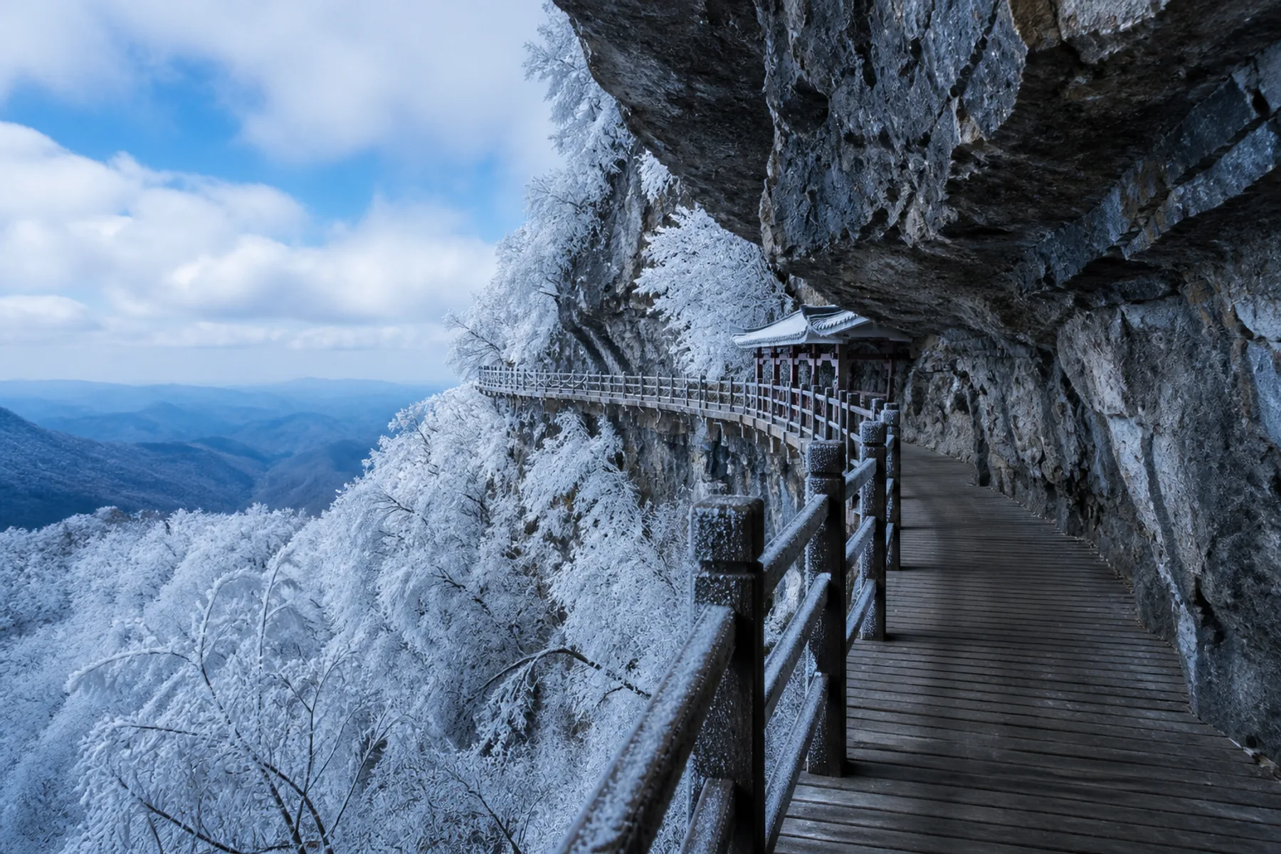 Winter view along a frosted Tianmen Mountain cliffside plank walk