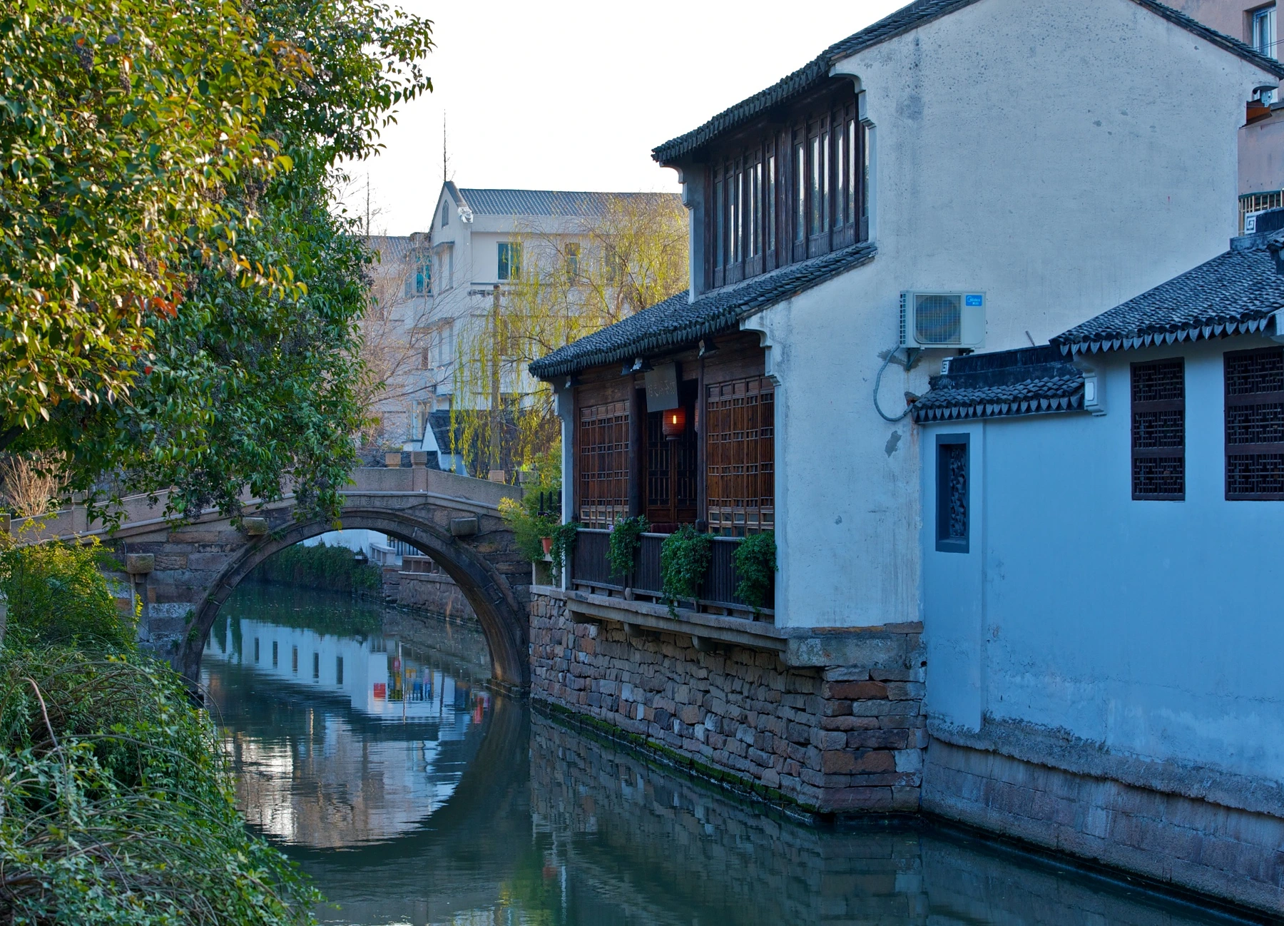 Stone arch bridge across a narrow canal in Pingjiang district