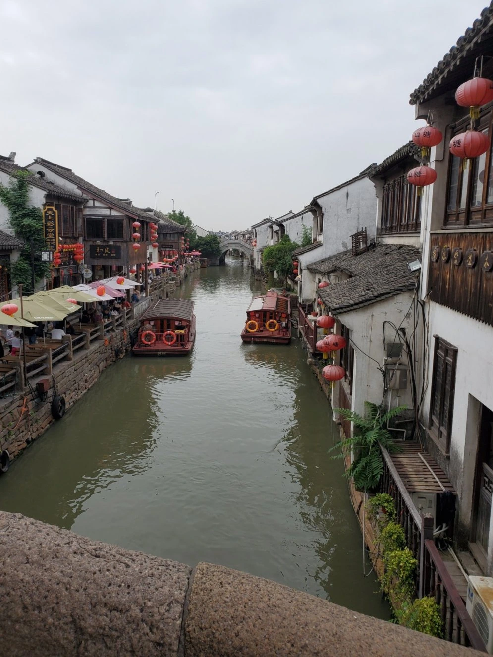 Daytime canal, traditional houses and boats along Shantang Street