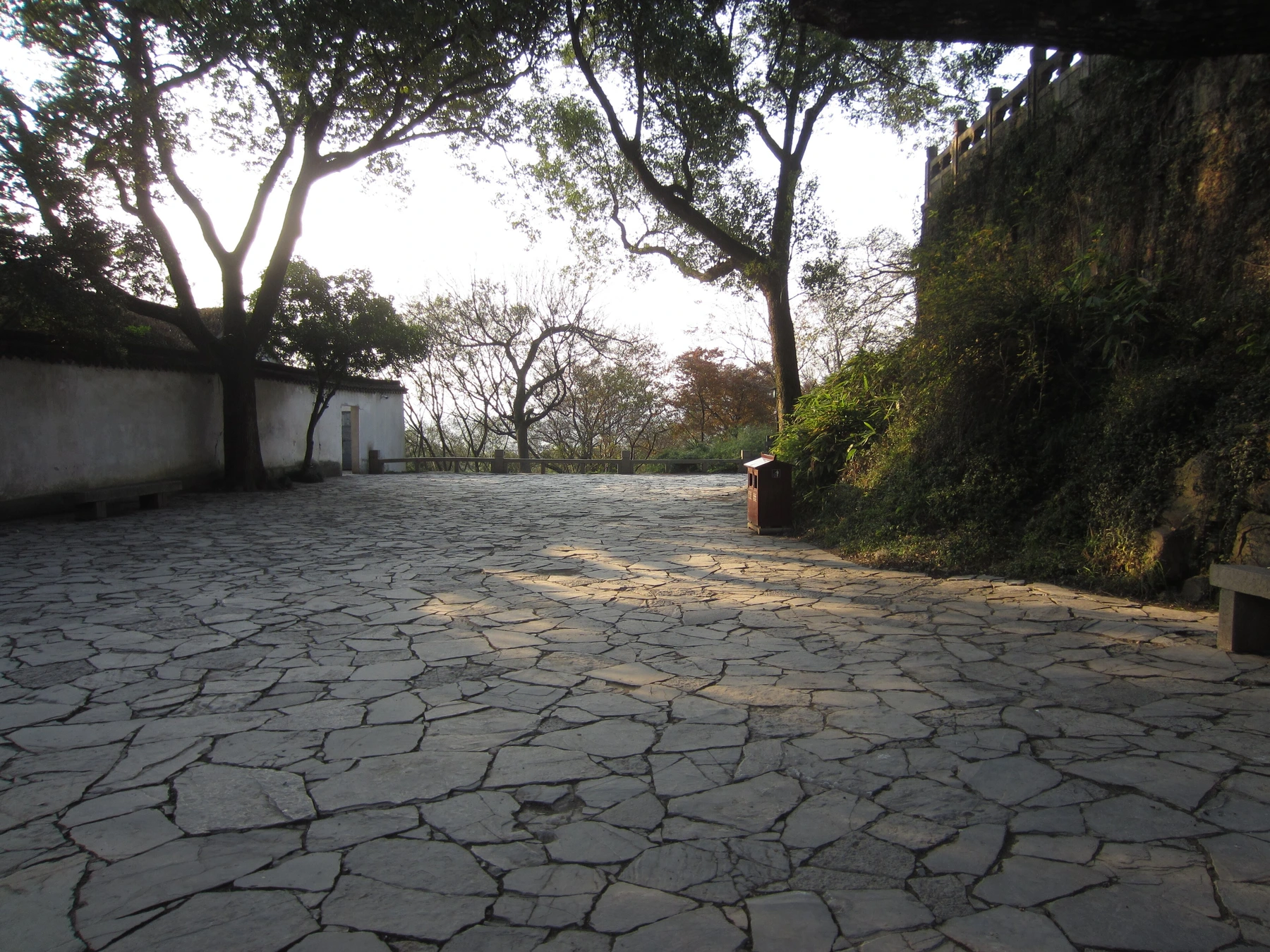 Stone route beneath walls and trees on Tiger Hill