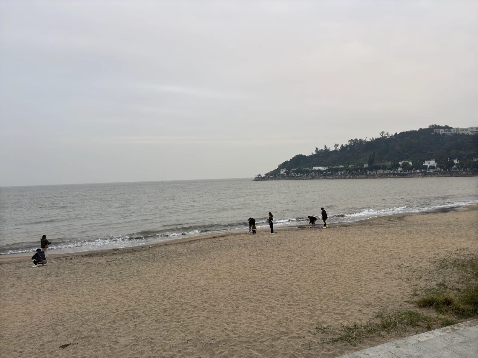 Hac Sa Beach and the Coloane east-coast headland under overcast weather