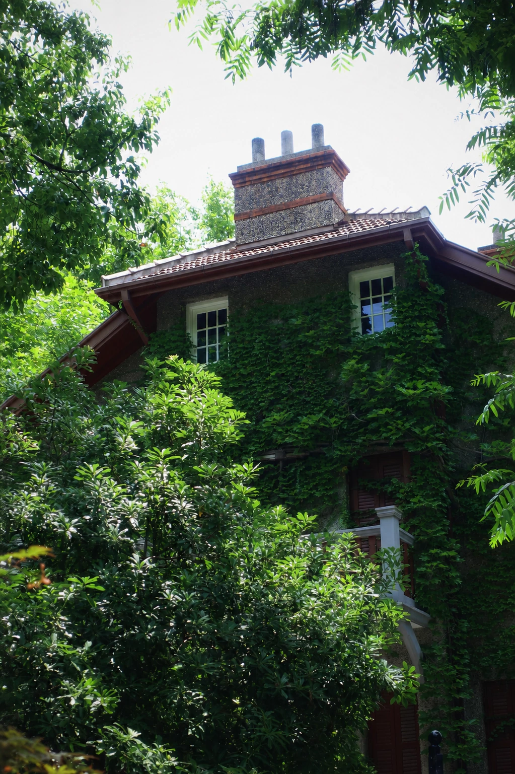 An ivy-covered historic garden house at Sinan Mansions in Shanghai