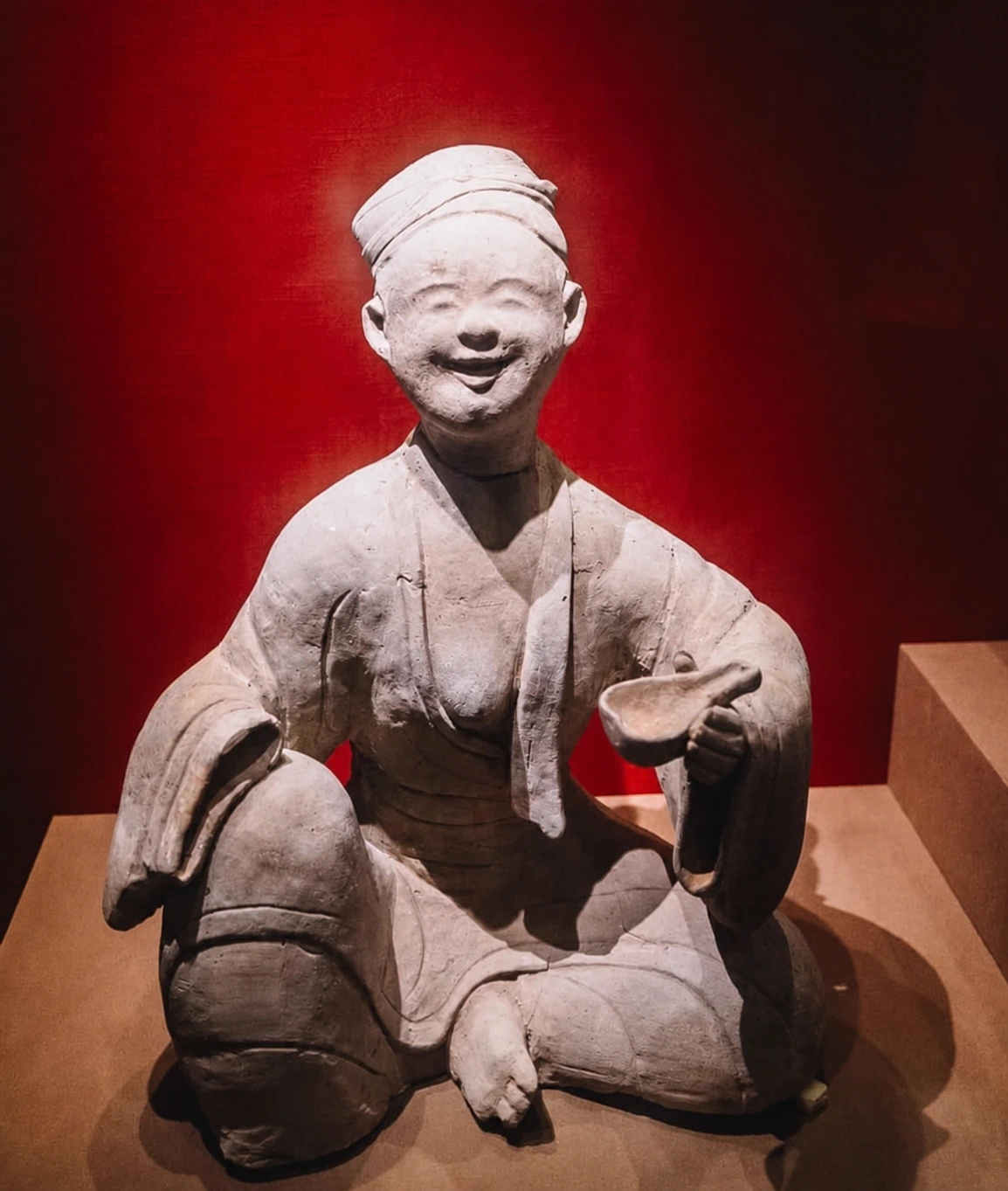 Smiling clay figurine displayed at Chengdu Museum