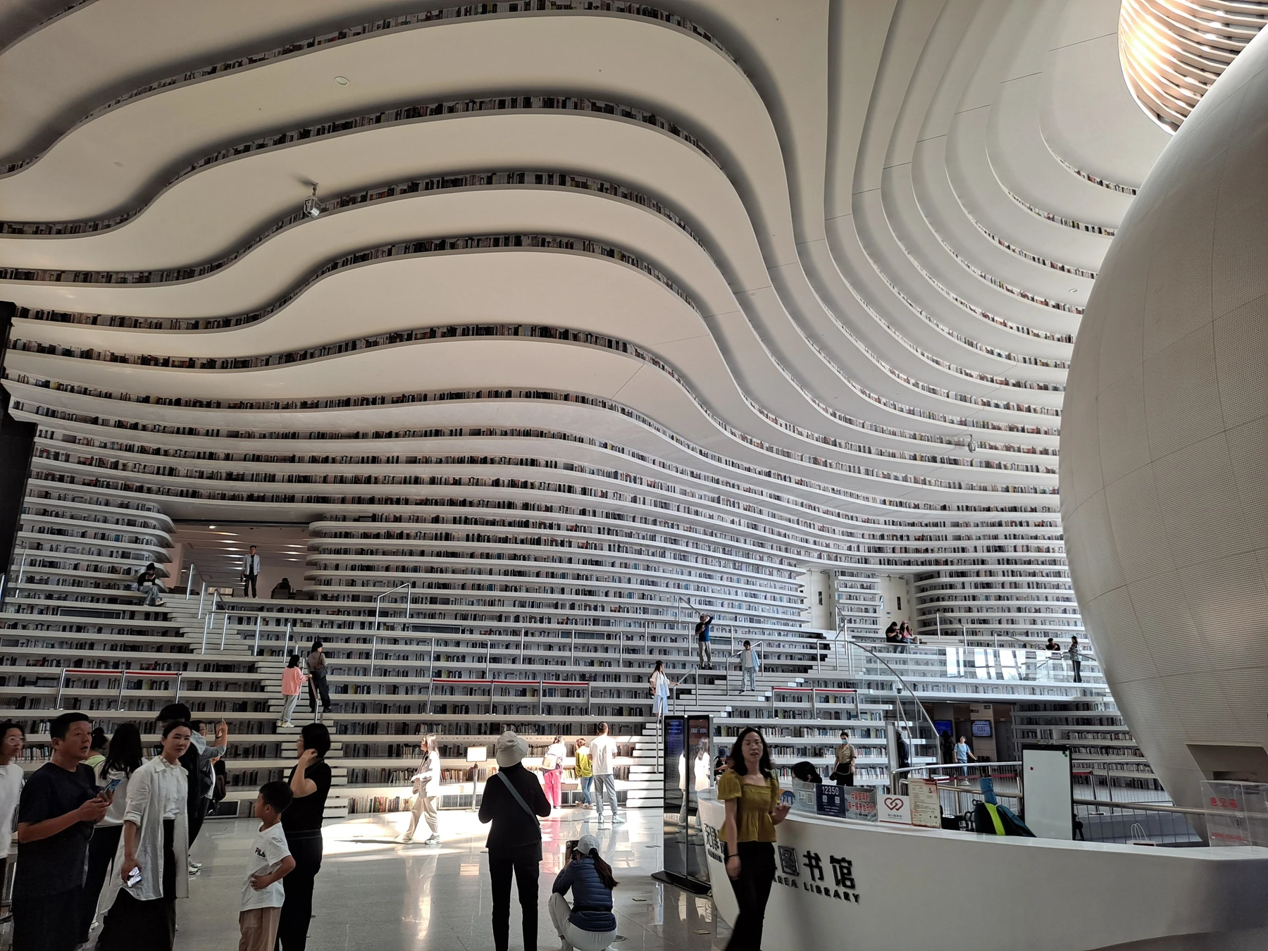 Circular auditorium and eye-like opening in Binhai Library atrium