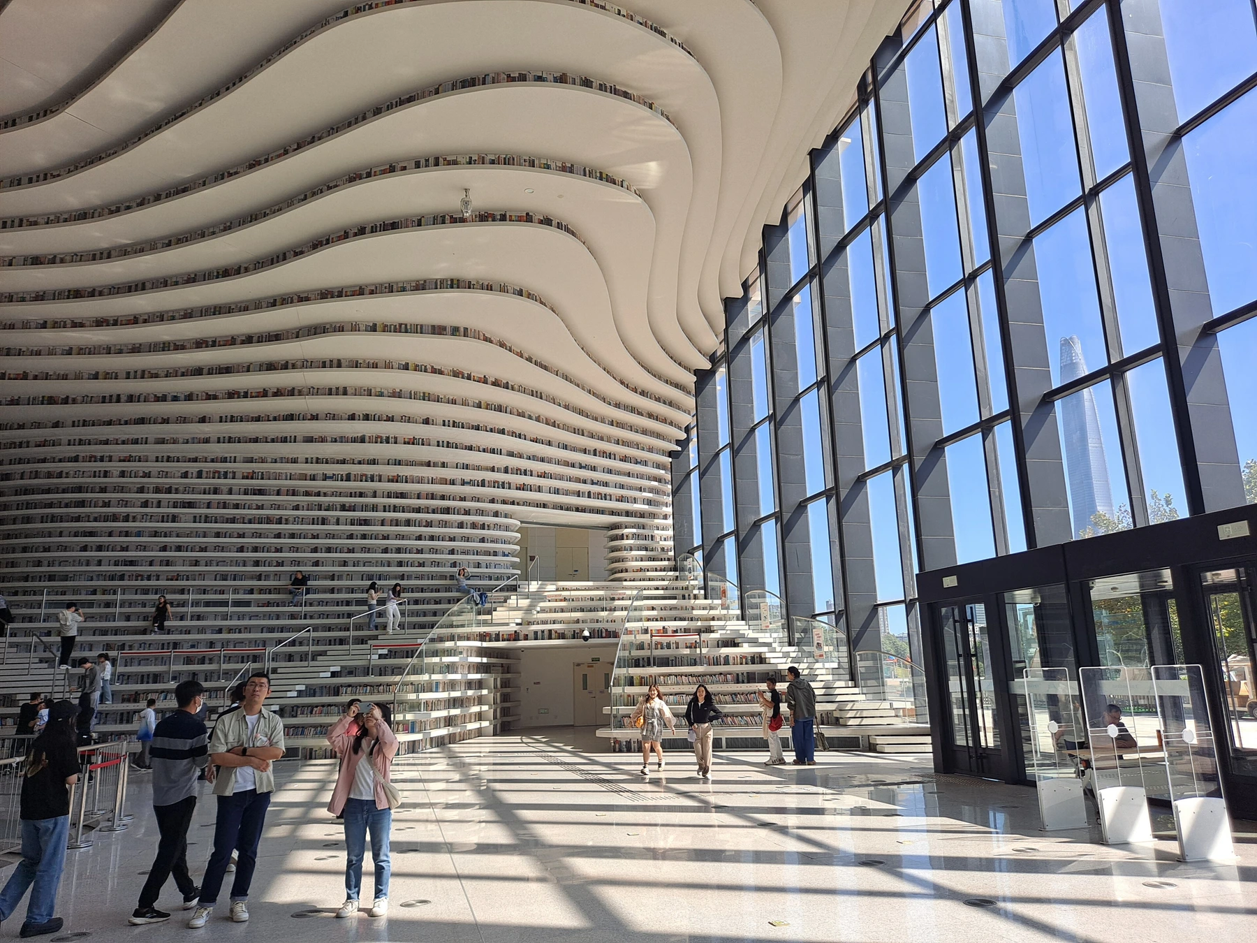 Curving white terraces and shelves inside Binhai Library