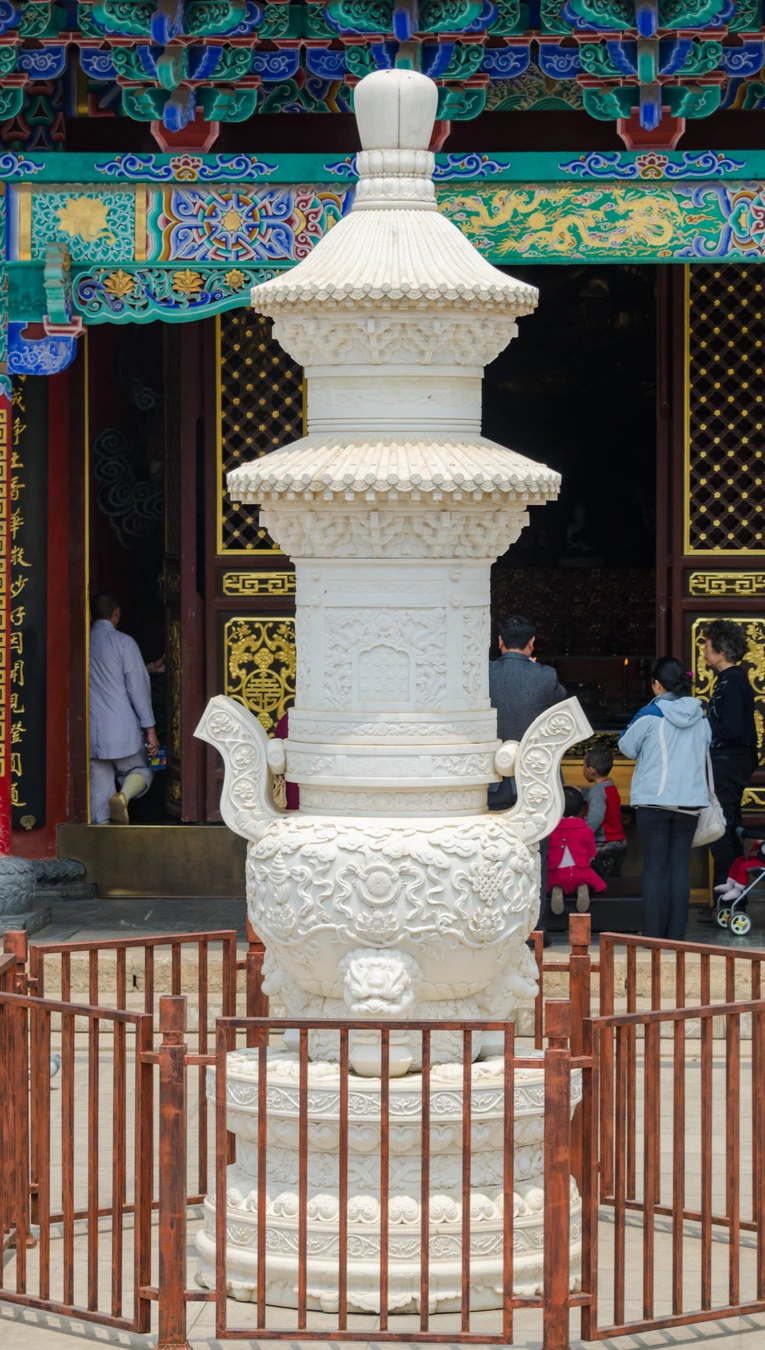 White carved incense structure before a hall at Yuantong Temple