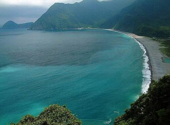 Curving beach and green headland on Zhuhai's Dong'ao Island