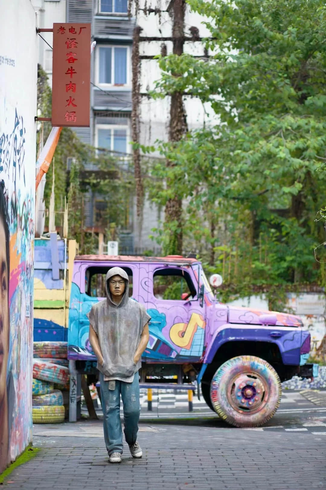 Street art and pedestrians at Huangjueping Graffiti Street