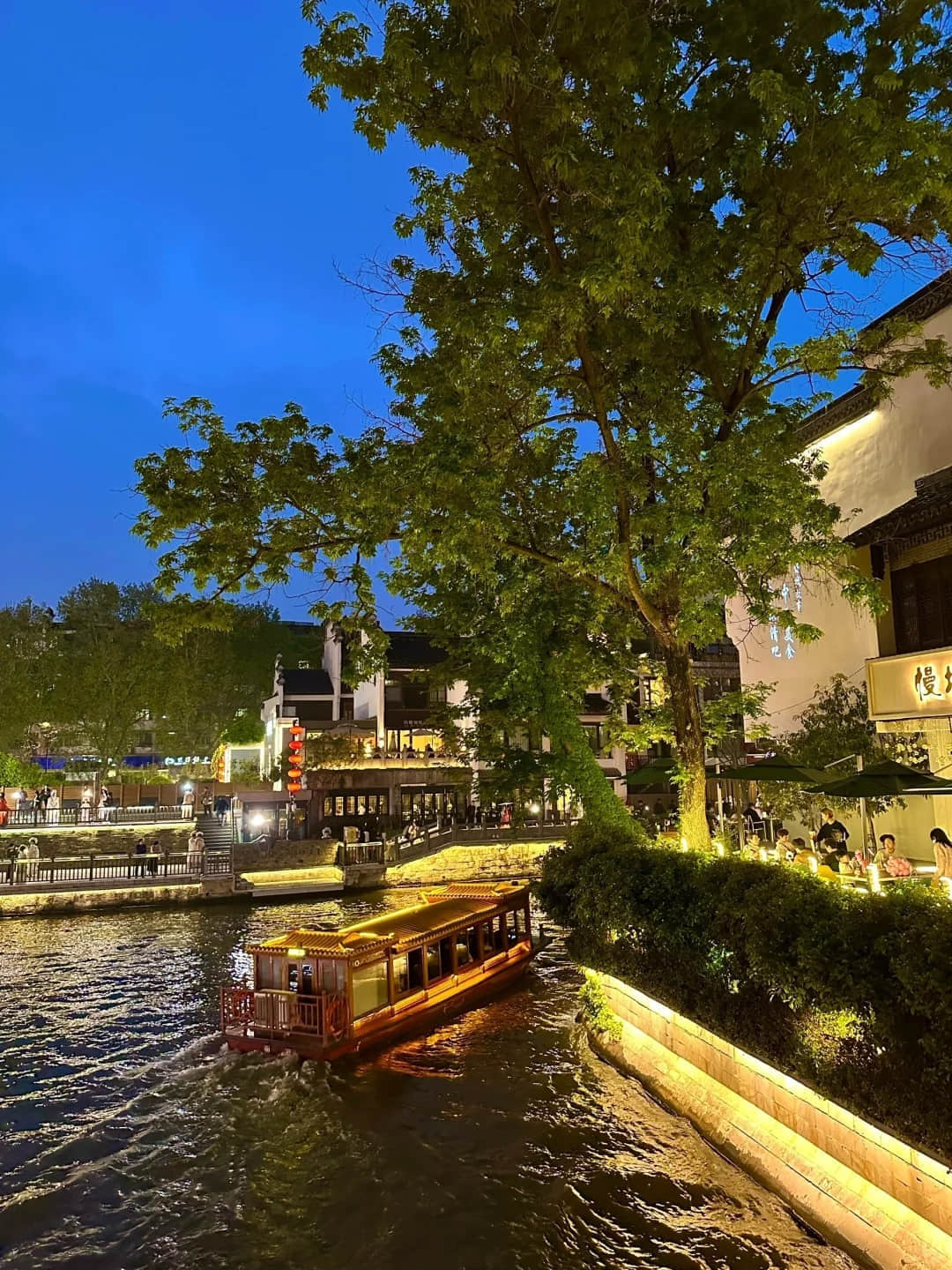 Qinhuai River at night with illuminated buildings and boats